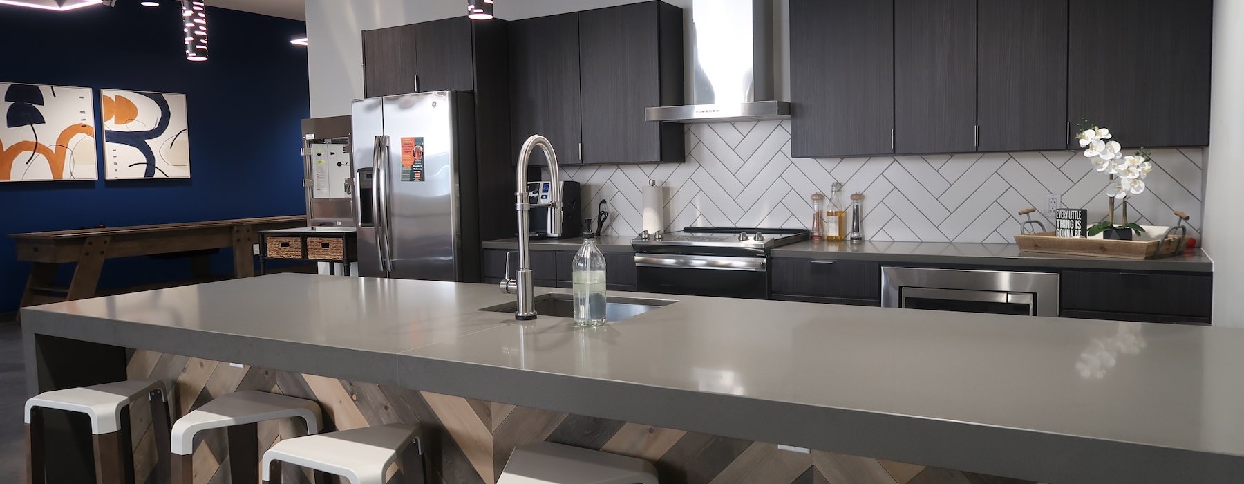 a kitchen with stools and a bar