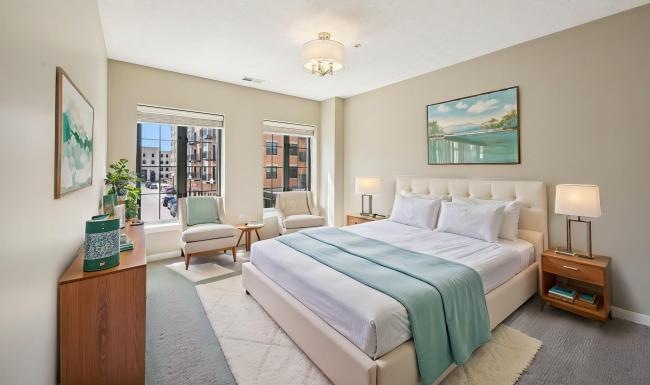 a bedroom with a bed and chairs