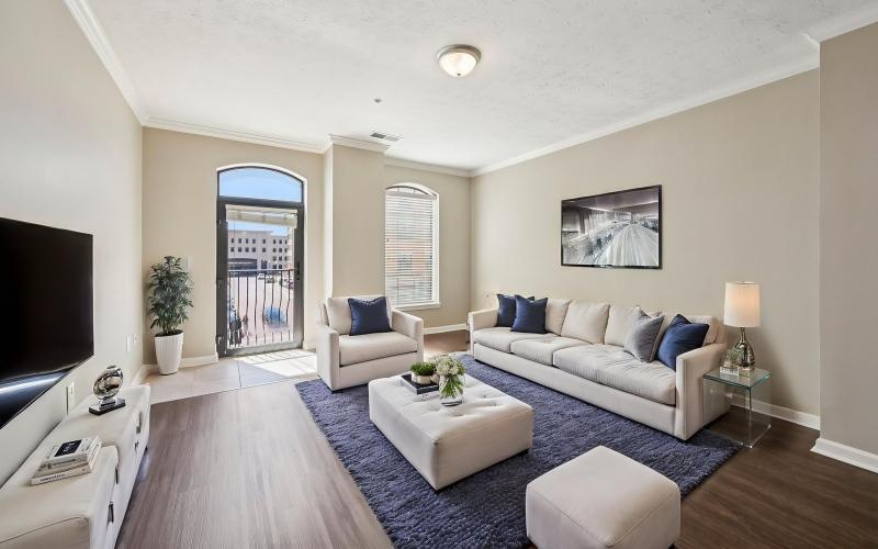 a living room with a tv, couch and chairs